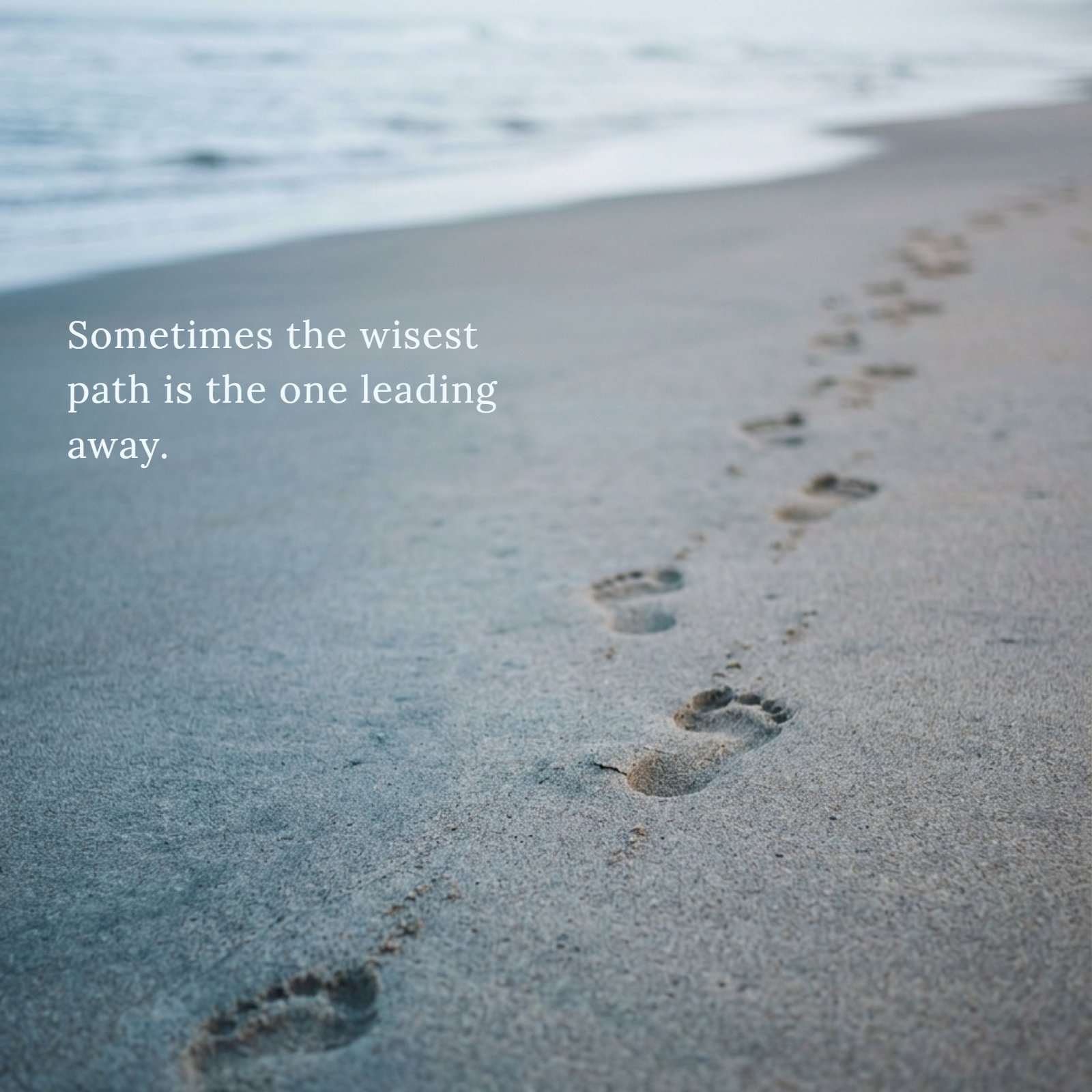 A soft-focus, blue-grey toned photograph of two footprints in the sand leading in opposite directions, with the text overlay: 'You can love someone and still walk away — that's not weakness, that's wisdom.'