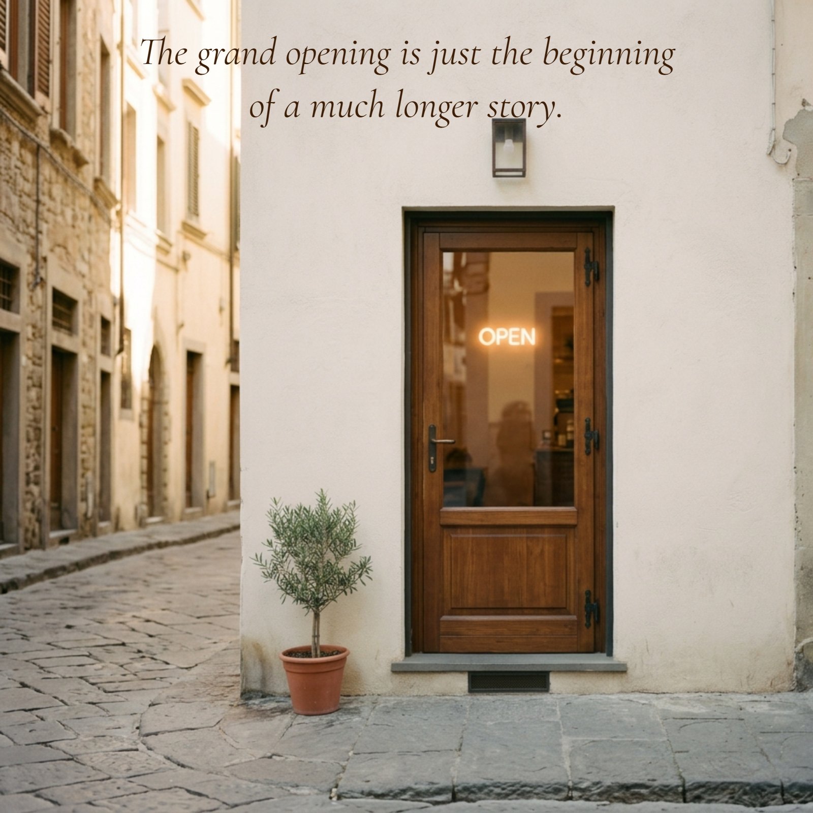 Minimalist photo of a wooden storefront door with a soft glowing "Open" sign and warm morning light, featuring the quote, "The grand opening is just the beginning of a much longer story."
