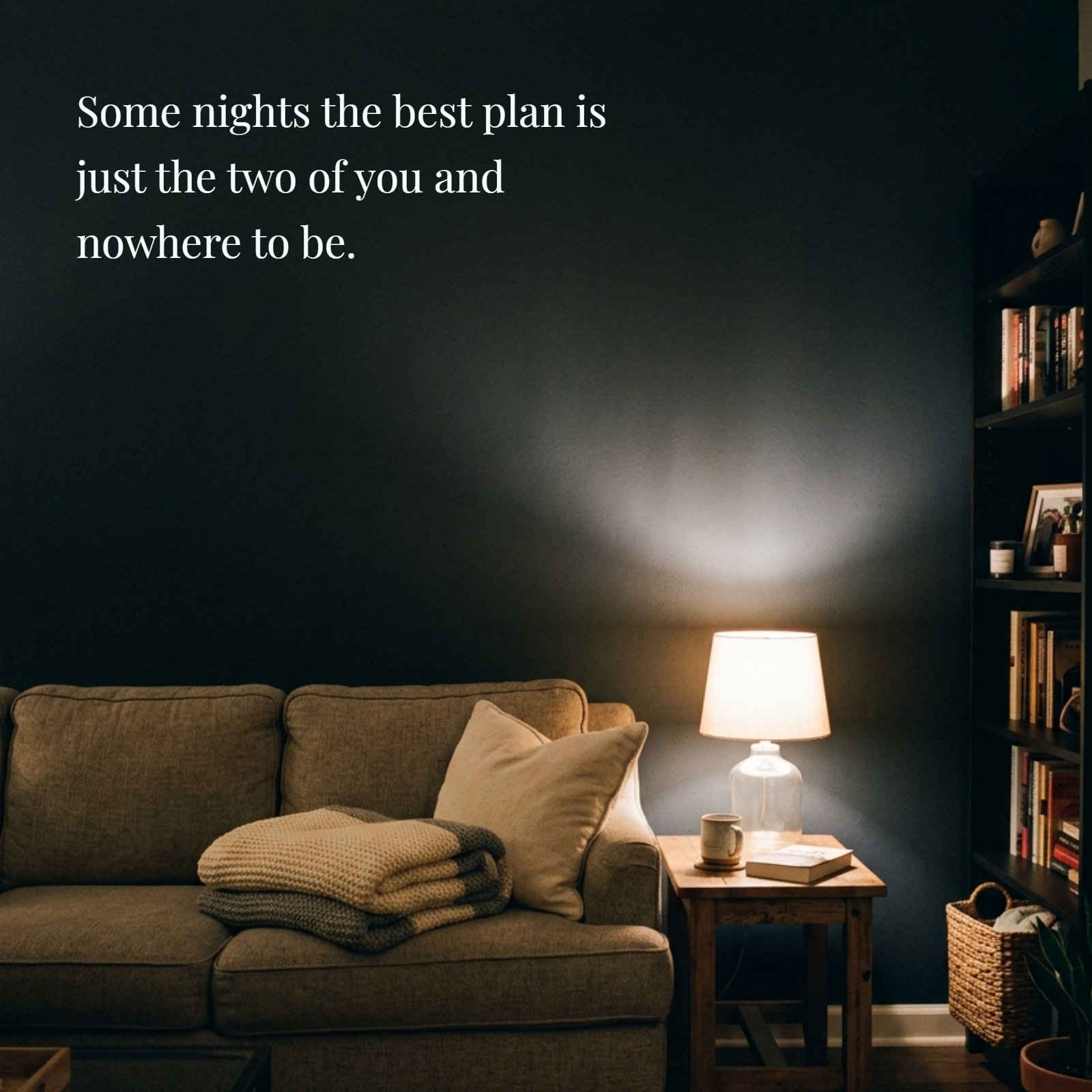 A dim living room at night featuring a folded blanket on a couch under soft lamplight, with the quote Some nights the best plan is just the two of you and nowhere to be written on the wall.