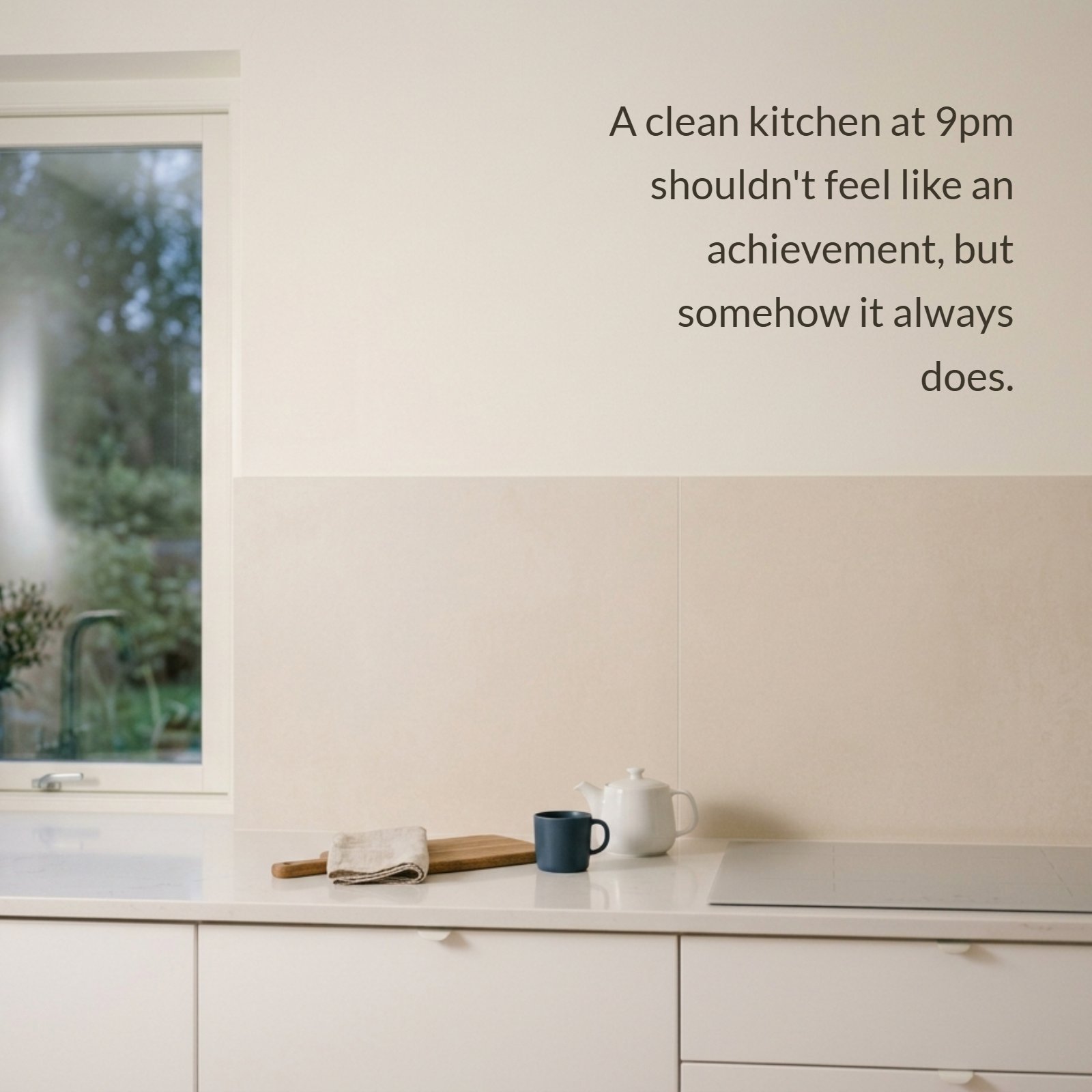 A minimalist 4:5 photograph of a clean, bright kitchen counter at 9pm with soft evening light and a blank pale wall backsplash.