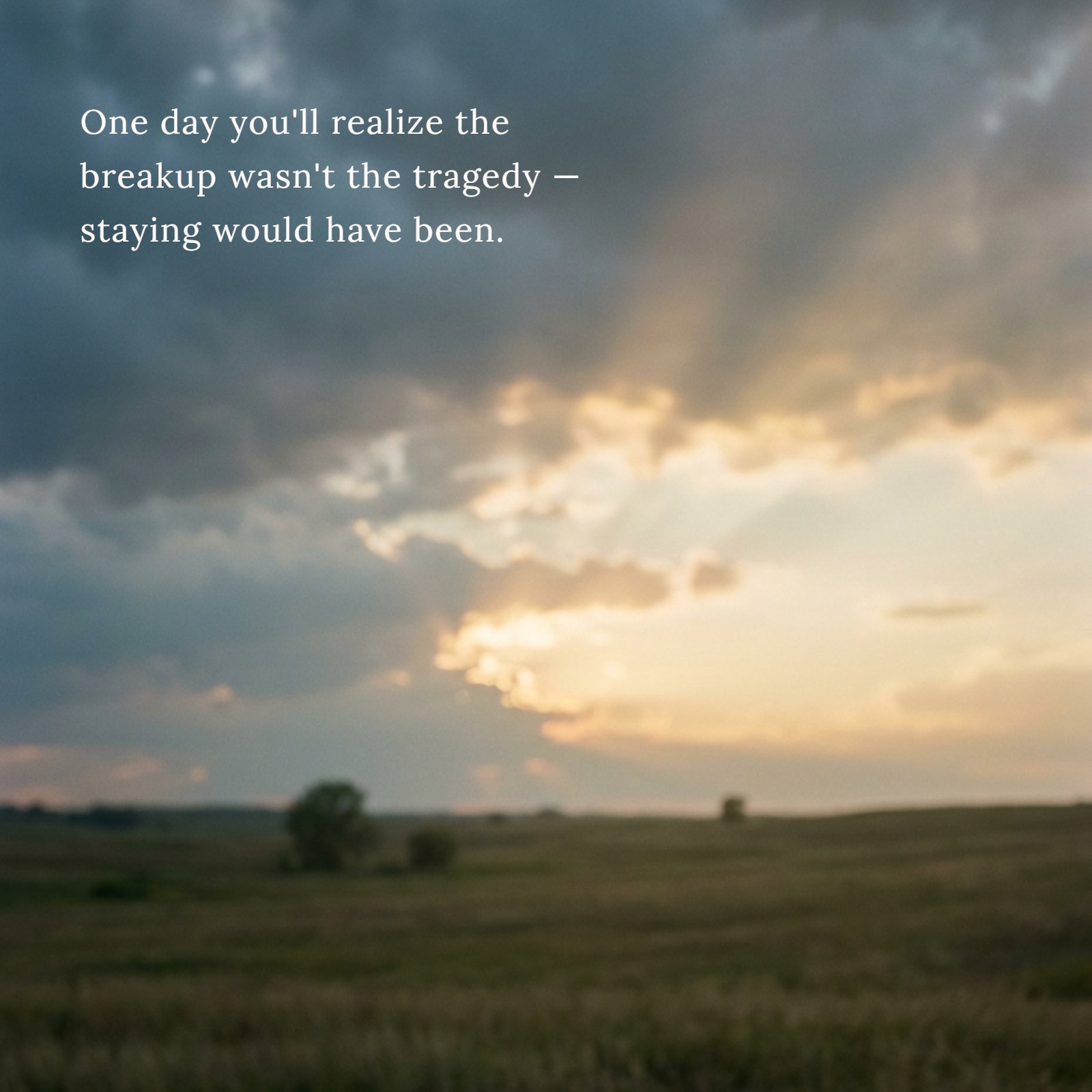 A blurred photograph shows a quiet field under a heavy storm cloud sky that is parting to reveal soft, warm golden light. The overall mood is hopeful. The quote 'One day you'll realize the breakup wasn't the tragedy — staying would have been' is overlaid on the upper portion of the image.