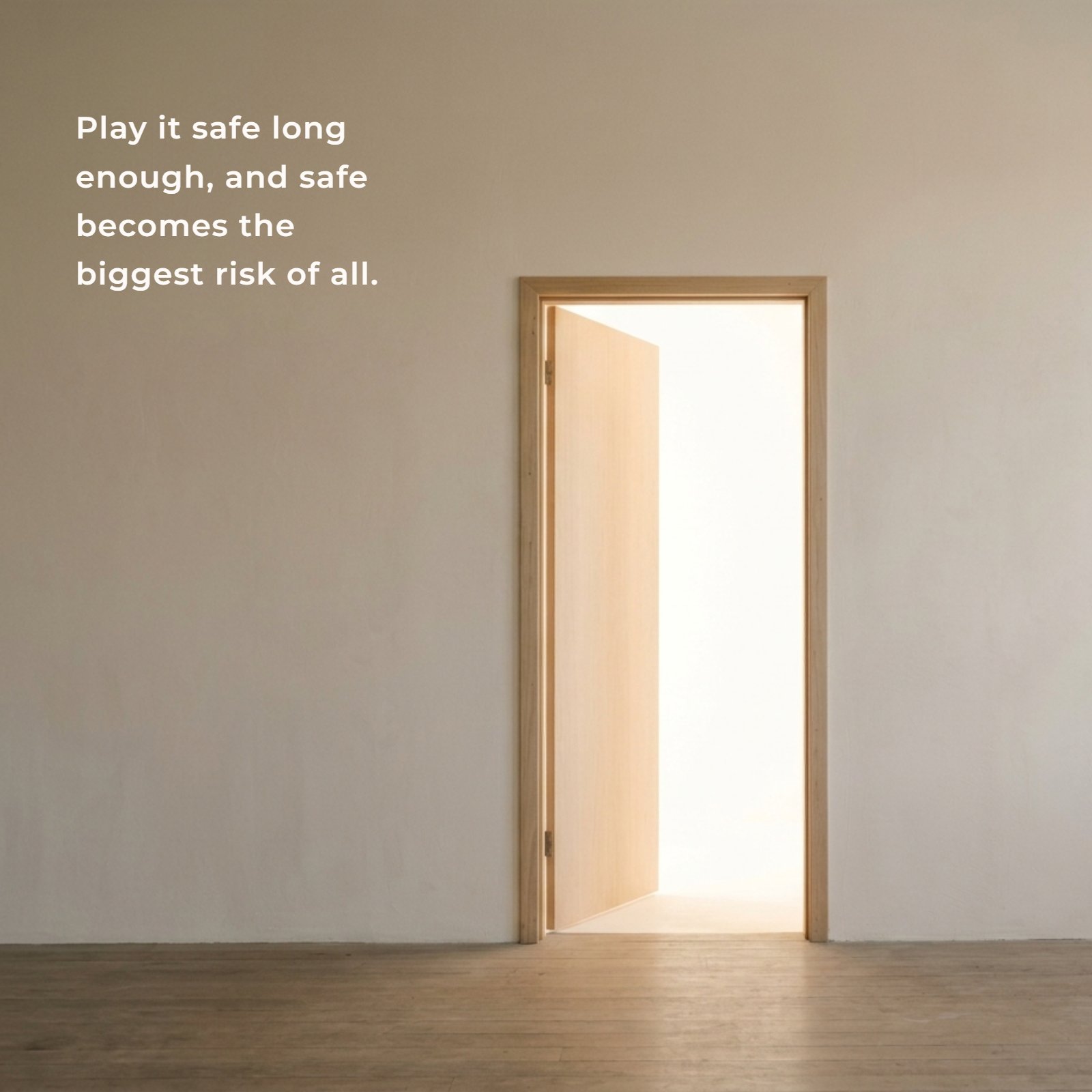 A vertical minimalist photograph of a plain wall with a single open wooden door leading into a room filled with bright, diffused light. The quote "Play it safe long enough, and safe becomes the biggest risk of all." is centered on the wall.