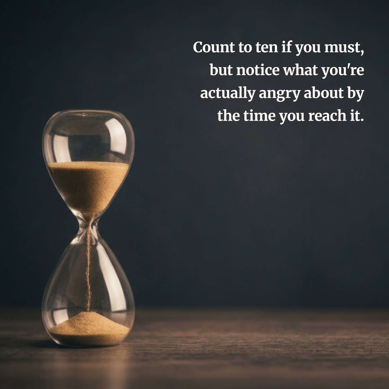 Minimalist photo of a glass hourglass with golden sand flowing against a dark background, illustrating a quote about counting to ten and understanding anger.