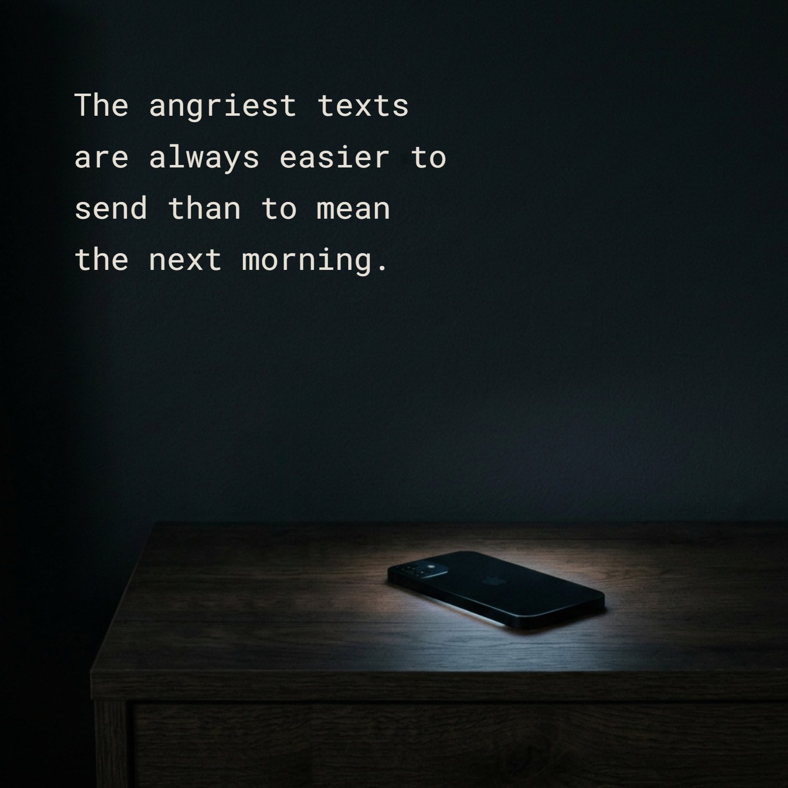 A smartphone is face-down on a wooden nightstand in a dark room. The quote 'The angriest texts are always easier to send than to mean the next morning' is written in the large dark empty wall space above it. A soft blue glow is visible under the phone.