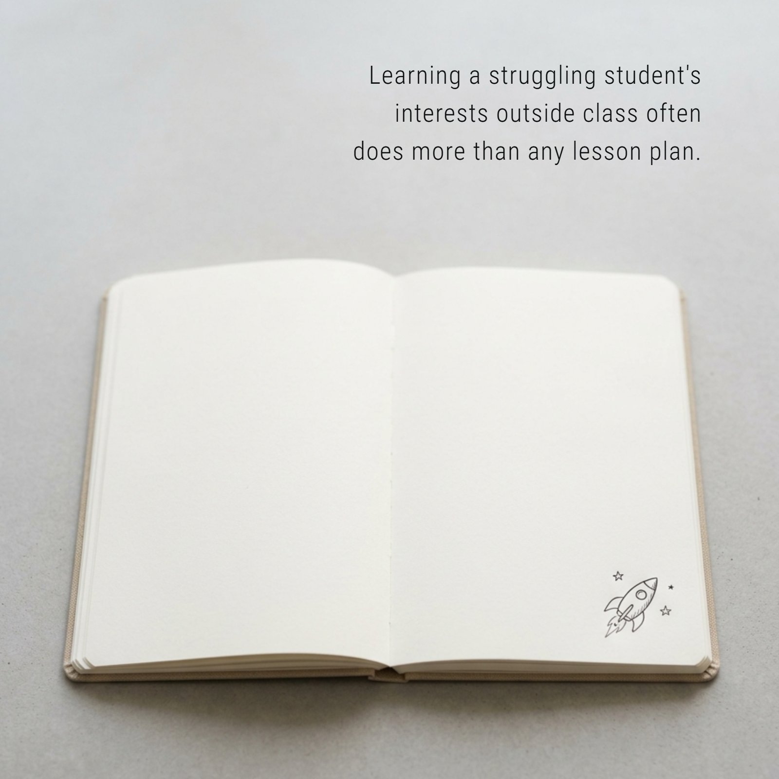A clean, minimalist photo of a single, open notebook on a plain desk with soft lighting, featuring a small doodle and the quote: 'Learning a struggling student's interests outside class often does more than any lesson plan.'