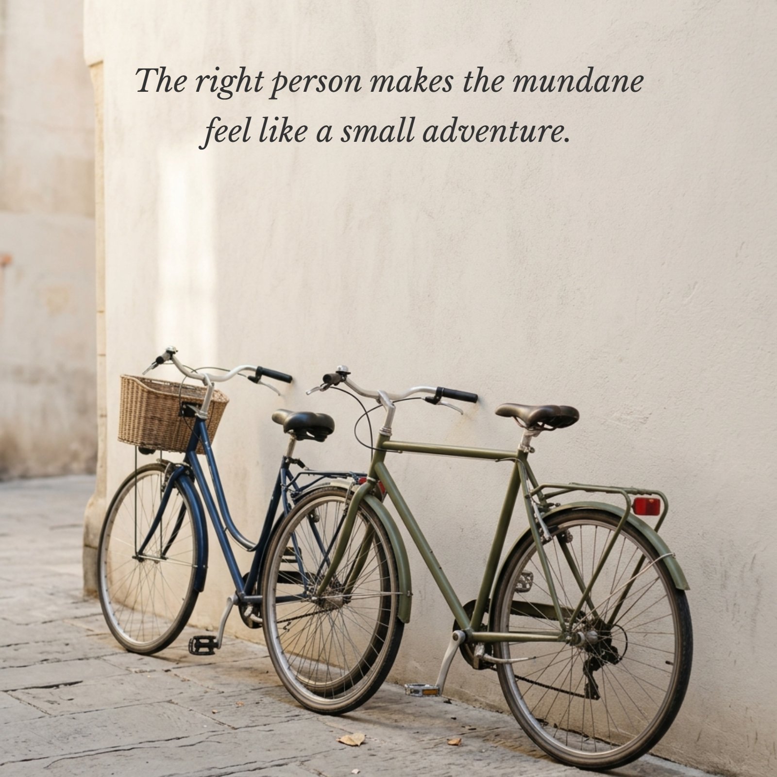 Minimalist 1:1 photograph of two bicycles leaning against a textured wall in soft afternoon light, with the quote text "The right person makes the mundane feel like a small adventure" centered above them.