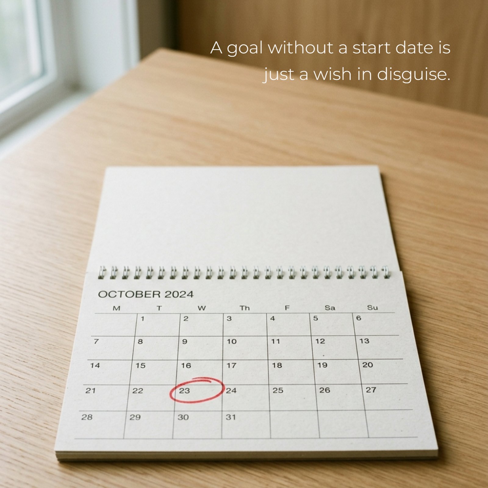Minimalist image of a calendar on a desk with a date circled, symbolizing discipline and the quote "A goal without a start date is just a wish in disguise."