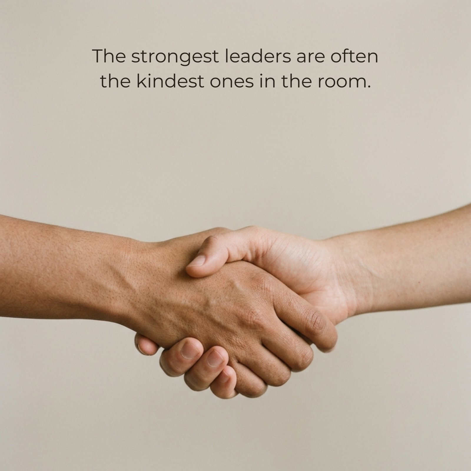 Minimalist 1:1 image of two hands in a firm, warm handshake. The photo has soft light and a simple beige background with negative space for text. The caption, 'The strongest leaders are often the kindest ones in the room,' can be written on this image.