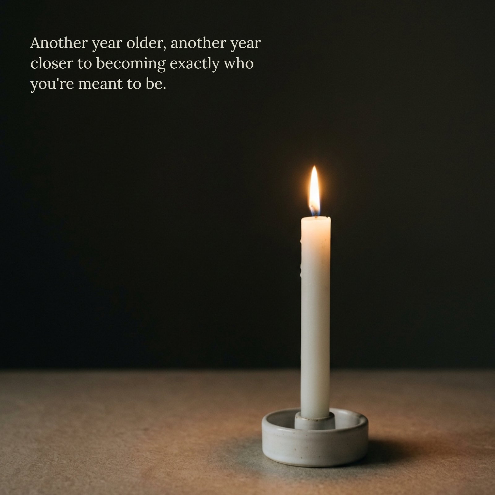 A minimalist image with plenty of dark negative space for text, featuring a single, white lit candle in a ceramic holder.