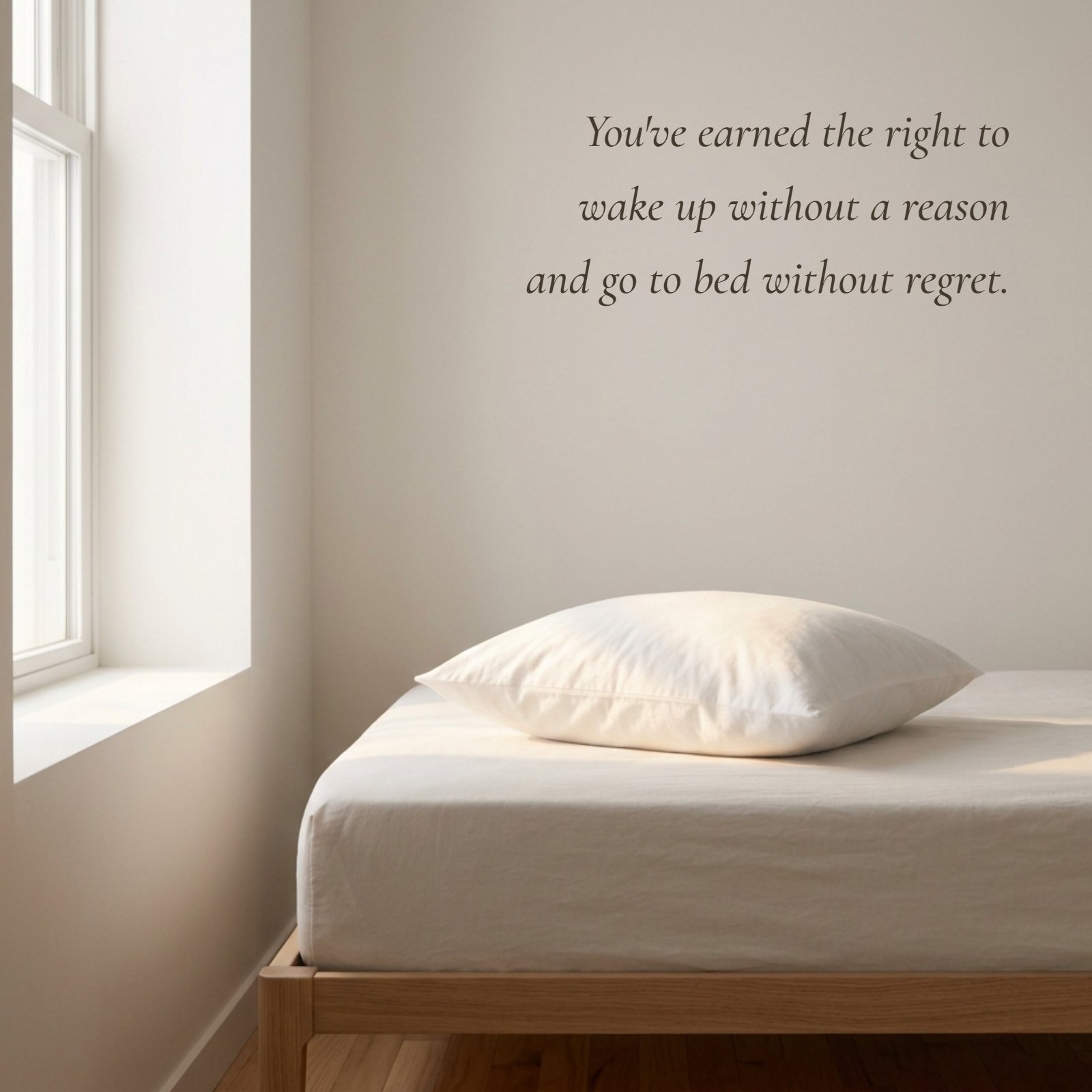 A minimalist photo showing a single soft pillow resting in warm morning light on a bed in a plain room. The retirement quote 'You've earned the right to wake up without a reason and go to bed without regret.' is written in clean typography across the negative space.