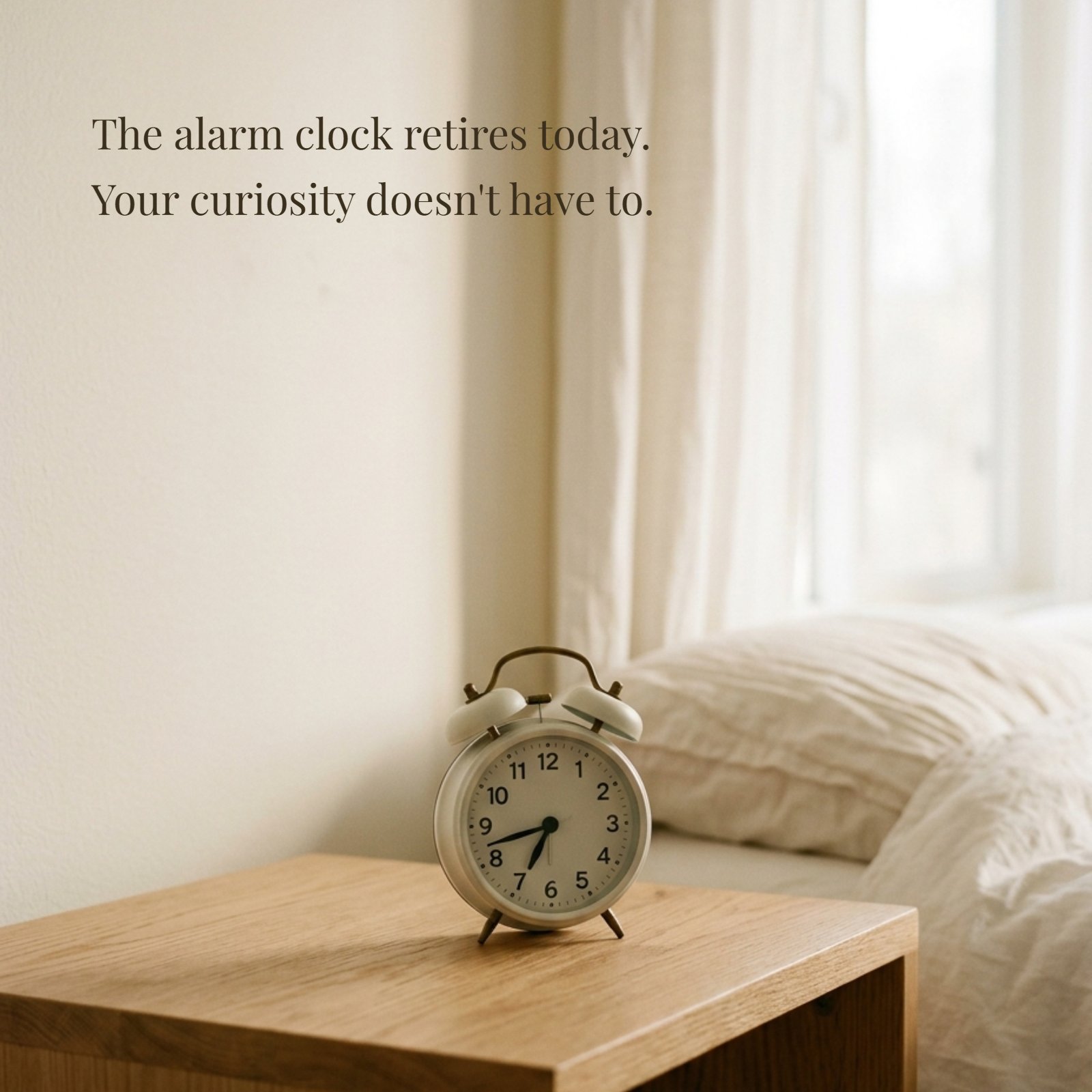 A minimalist photograph of a classic alarm clock on a warm-toned wooden nightstand, illuminated by soft morning light. The inspirational quote "The alarm clock retires today. Your curiosity doesn't have to." is written on the image.