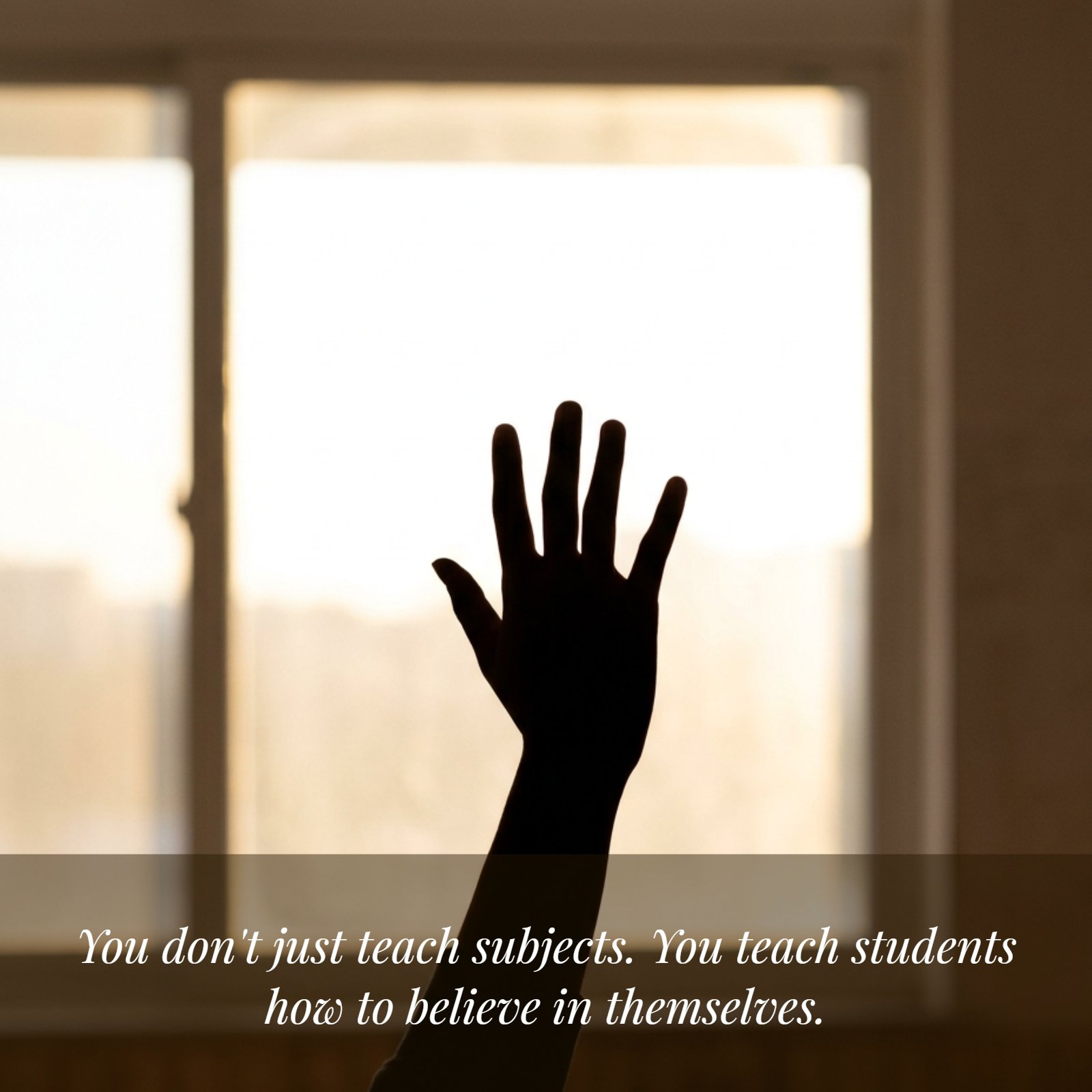 A minimalist vertical photograph showing a single raised hand in silhouette against a soft, sunlit classroom window.
