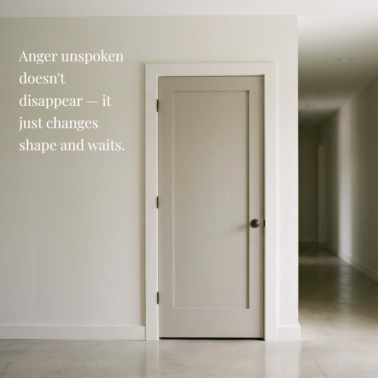 A minimalist photograph of a single closed door in a soft, muted light within a plain neutral hallway with negative space. The text on the image is 'Anger unspoken doesn't disappear — it just changes shape and waits.'