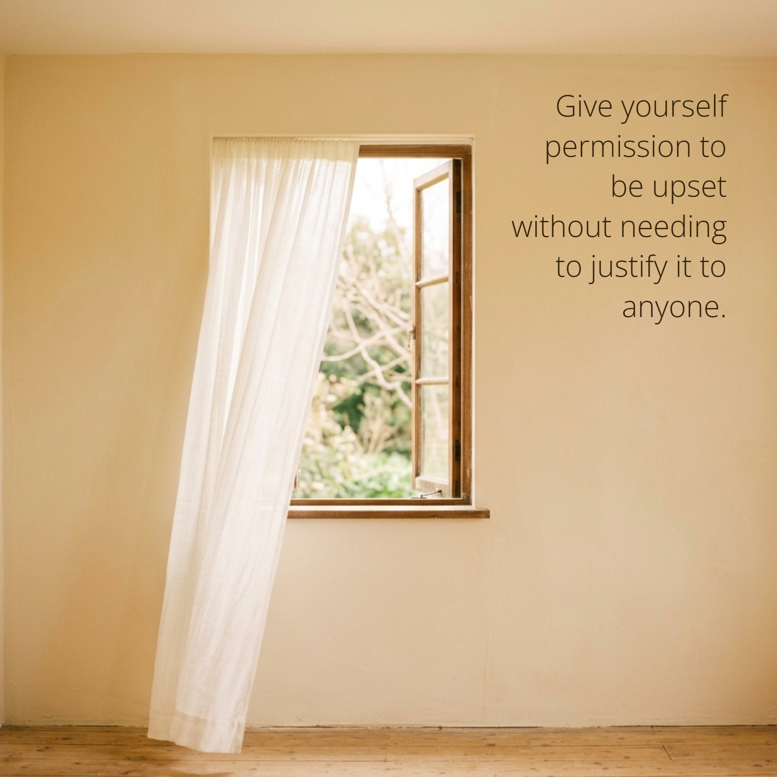 A minimalist photo of a single open window in a neutral room with a soft curtain moving, featuring the quote "Give yourself permission to be upset without needing to justify it to anyone."